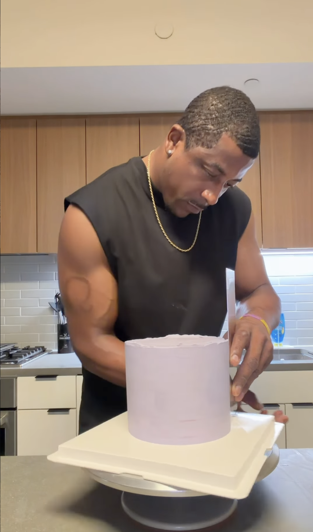 Welldunn's baker smoothing a fresh cake